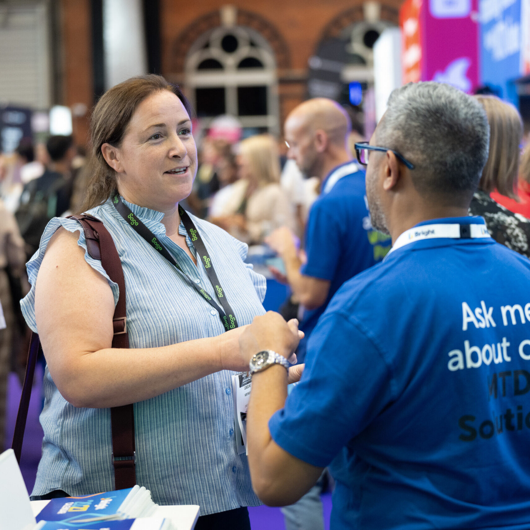 Male Exhibitor and Female visitor having a happy interatcion